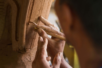 A man sculpts a piece of wood